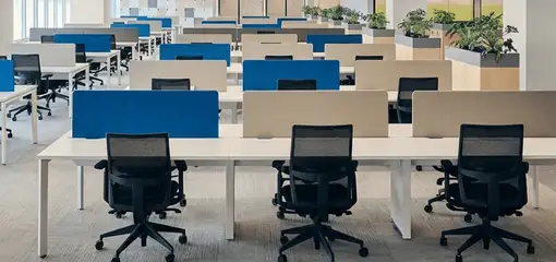 Modern open-plan office space featuring clean workstations, ergonomic chairs, and sanitized carpets provided by professional office cleaning services in Albuquerque, NM.