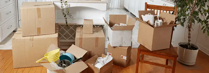 Packed moving boxes and household items in a kitchen before move-out or move-in cleaning, Albuquerque, NM.